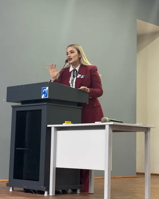 Speaking at a podium