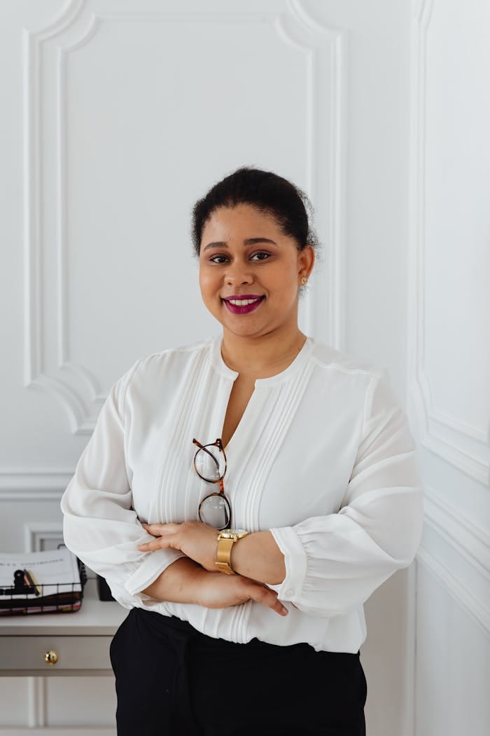 Confident African American woman in a professional setting with a friendly smile.